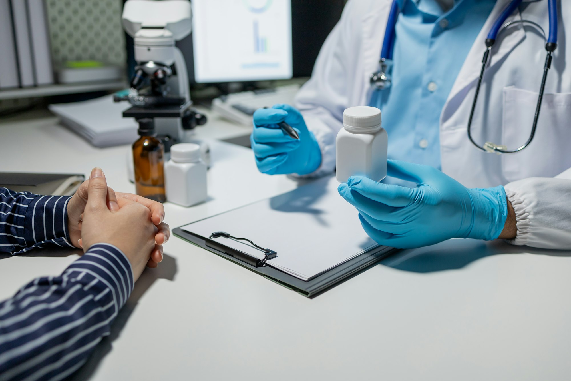 Doctor and patient in conversation about pill description, professional physician wearing white coat
